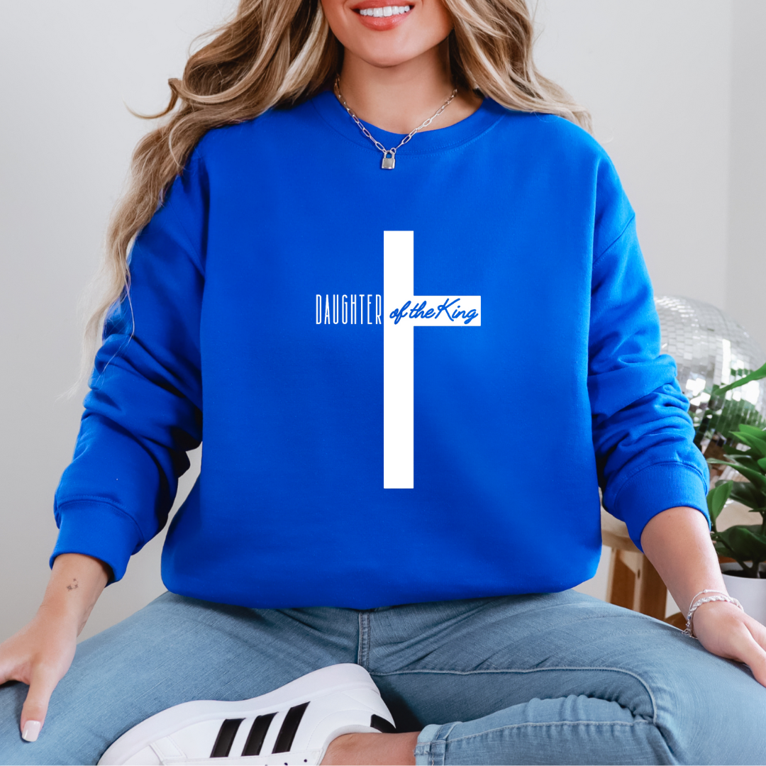 Blue sweatshirt that says, "daughter of the King" across the middle of a large cross. 