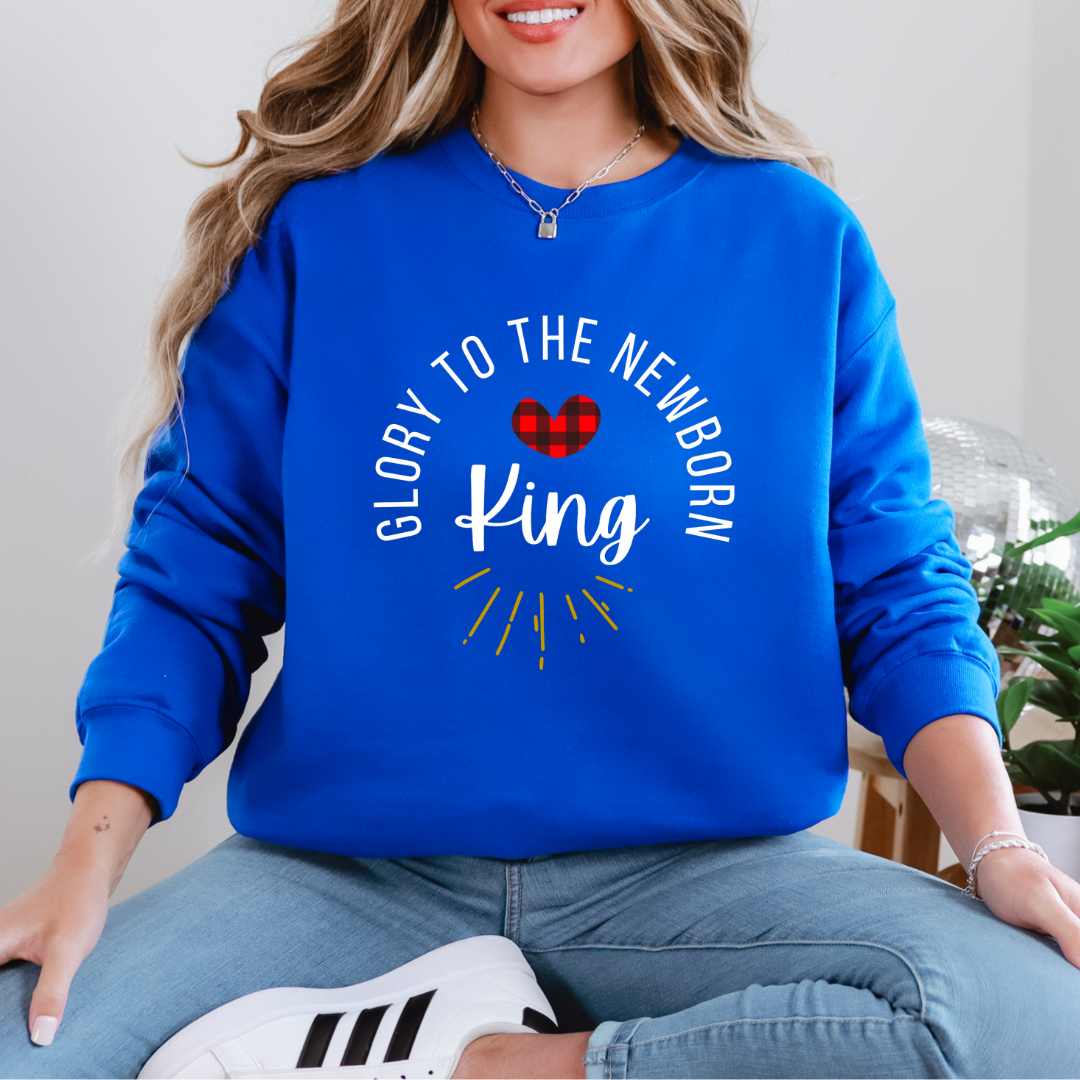 Royal blue sweatshirt that says, "Glory to the newborn King" with gold embellishment and buffalo plaid red heart.