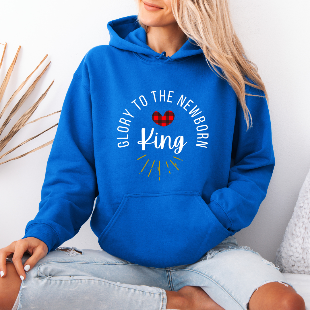 Royal blue hooded sweatshirt that says, "Glory to the newborn King" with gold embellishment and buffalo plaid red heart.