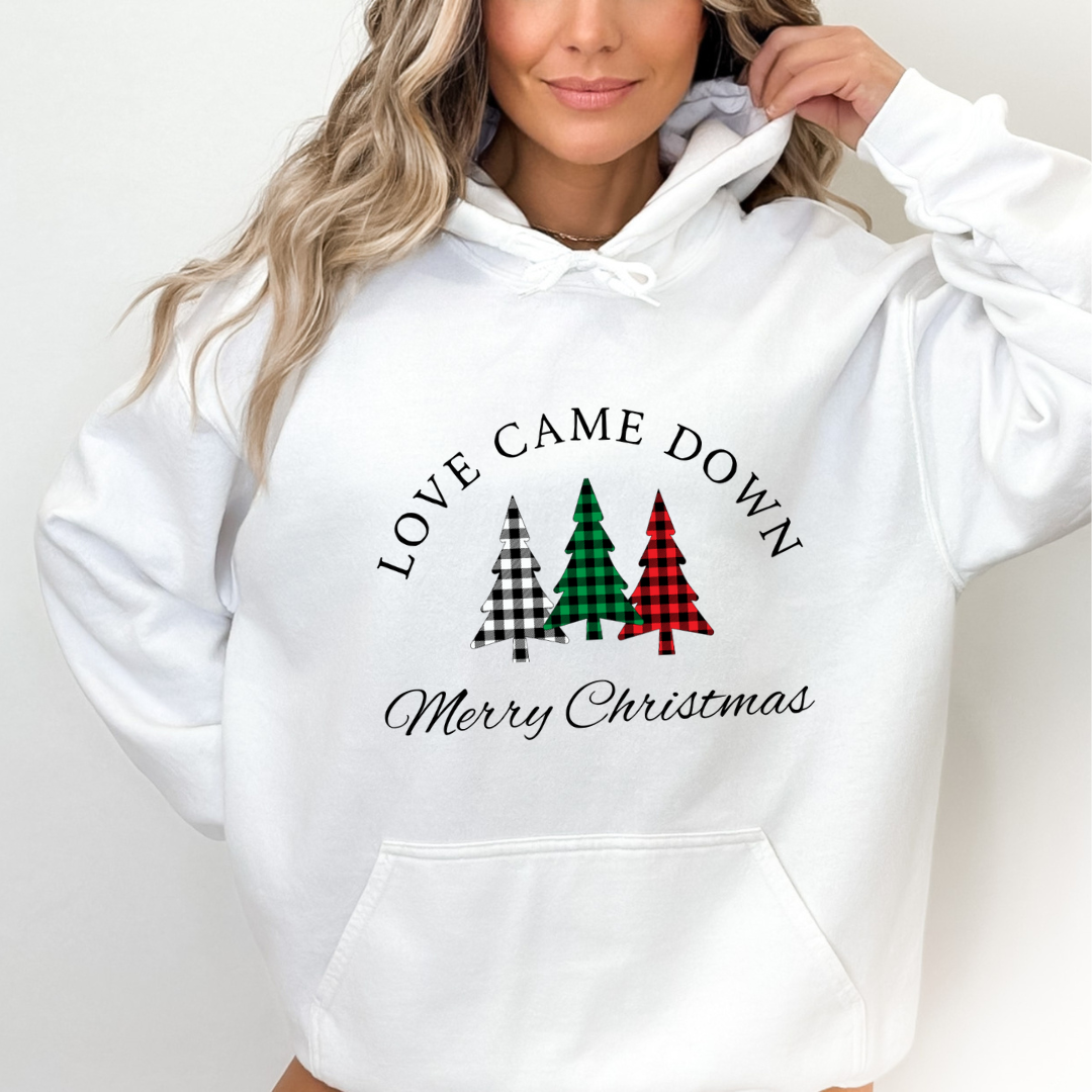 White hoodie sweatshirt that says, "Love came down. Merry Christmas" with three Christmas trees in buffalo plaid green, red and black. 