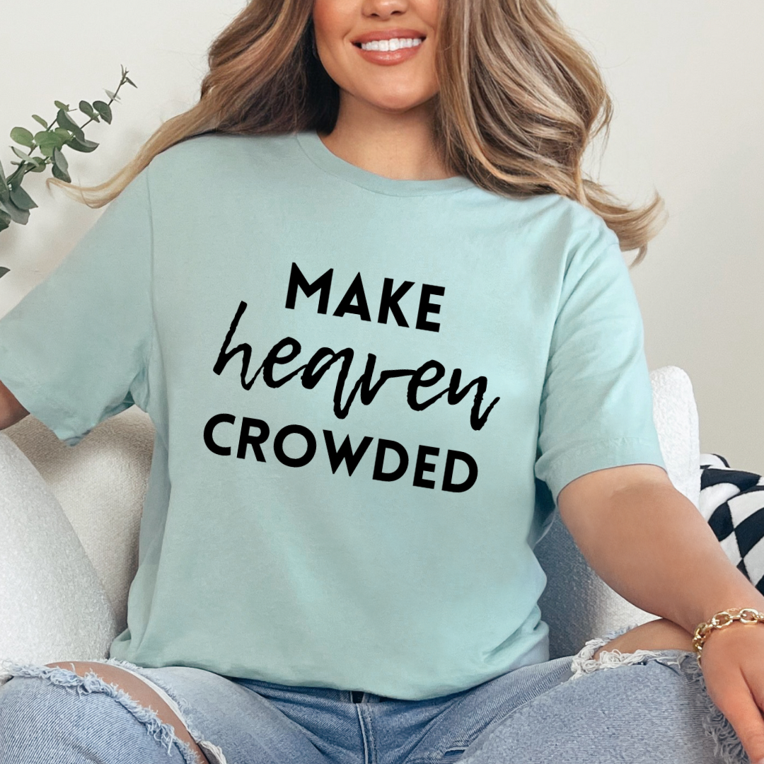 Dusty green crewneck t-shirt that says, “make heaven crowded.”