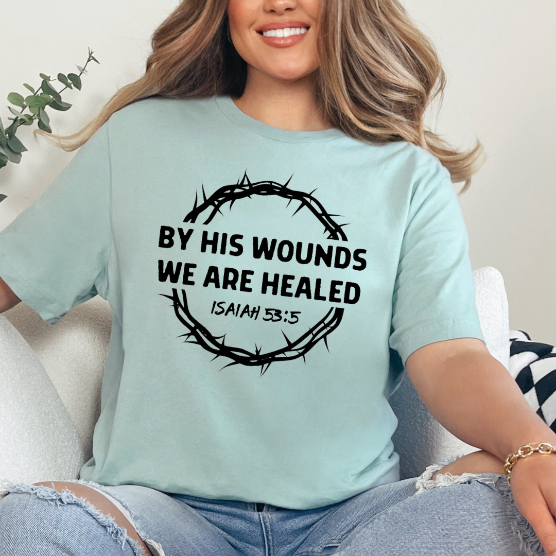 Dusty green Crewneck t-shirt that says, “by His wounds we are healed. Isaiah 53:5.”