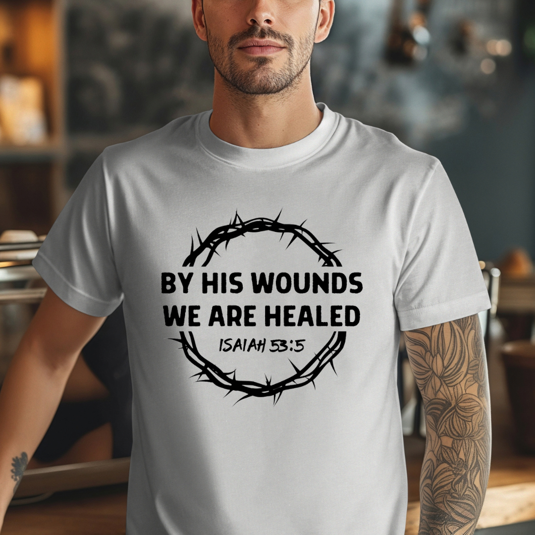 Grey Crewneck t-shirt that says, “by His wounds we are healed. Isaiah 53:5.”