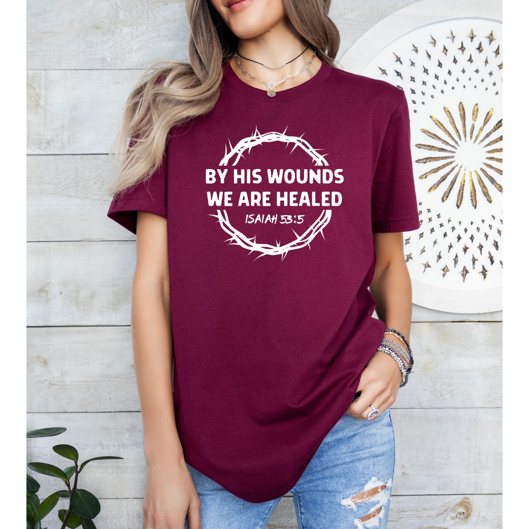 Maroon Crewneck t-shirt that says, “by His wounds we are healed. Isaiah 53:5.”