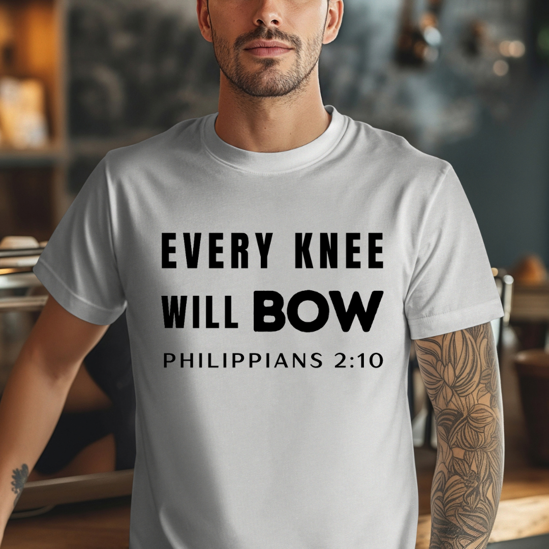 Grey crewneck t-shirt that says, “every knee will bow. Philippians 2:10.”