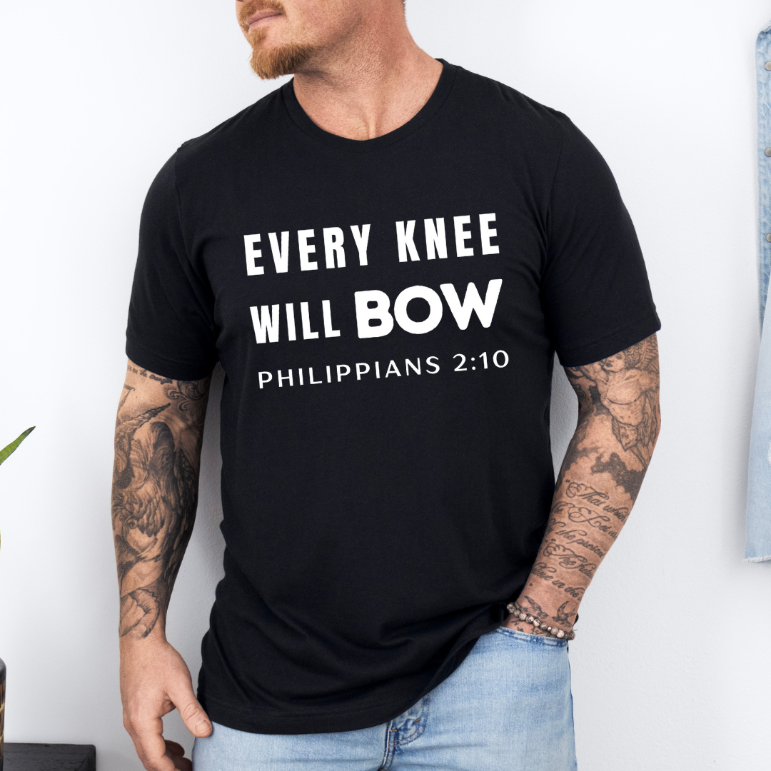 Black crewneck t-shirt that says, “every knee will bow. Philippians 2:10.”