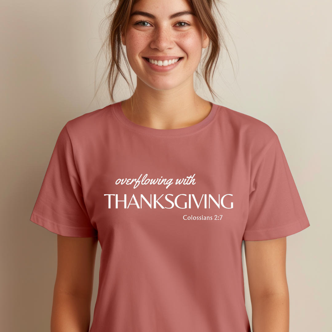 Mauve crewneck t-shirt that says, "overflowing with thanksgiving. Colossians 2:7." 